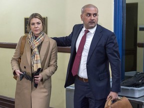 Bassam Al-Rawi, right, accompanied by an unidentified woman, arrives at provincial court in Halifax on Monday, Jan. 7, 2019 for his trial on a charge of sexual assault. This is the second trial for Al-Rawi in connection with what is alleged to have happened in his cab in May of 2015. The Nova Scotia Court of Appeal overturned the first decision on an error in law.