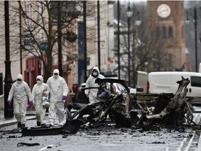 Forensic officers inspect the remains of the van used as a car bomb on an attack outside Derry Court House on January 20, 2019 in Londonderry, Northern Ireland. Dissident republicans are suspected to have carried out the attack which has been condemned by Northern Ireland politicians.