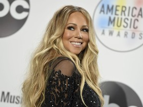 In this Oct. 9, 2018 file photo, Mariah Carey poses in the press room at the American Music Awards at the Microsoft Theater in Los Angeles. Carey’s 24-year-old Christmas classic is so popular it set a new one-day streaming record on Spotify on Christmas Eve.