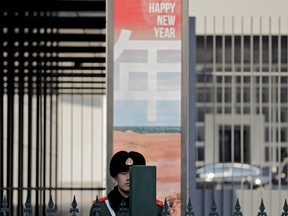 A Chinese paramilitary policeman stands guard at the Australian Embassy in Beijing, Thursday, Jan. 24, 2019.