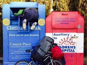 A Vancouver man attempting to remove items from a donation bin in this undated photo.