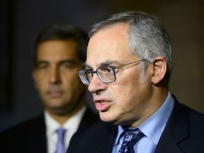 In this file photo, Conservative Shadow Minister for Justice Tony Clement and Shadow Minister for Public Safety and Emergency Preparedness Pierre Paul-Hus hold a press conference on Parliament Hill in Ottawa on Monday, Oct. 22, 2018.