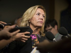 Ontario Deputy Premier Christine Elliott talks with journalists following Question Period at the Ontario Legislature in Toronto on Wednesday, August 1, 2018.