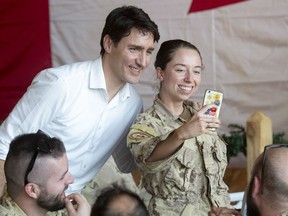 Prime Minister Justin Trudeau poses for a photo as he speaks with members of the Canadian Armed Forces personnel serving on the United Nations Multidimensional Integrated Stabilization Mission in Gao, Mali, Saturday, December 22, 2018.