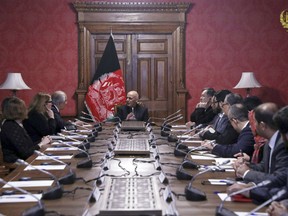 In this photo released by the Afghan Presidential Palace, Afghan President Ashraf Ghani, center, speaks to U.S. peace envoy Zalmay Khalilzad, third left, at the presidential palace in Kabul. Afghanistan, Monday, Jan. 28, 2019.