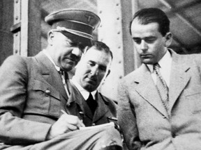 In this file photo dated Feb. 19, 1937, German Chancellor Adolf Hitler, left, discusses plans for building a convention hall at Nuremberg with Lord Mayor Willy Liebel, centre, and Prof. Albert Speer, right, at Nuremberg, Germany. Hilde Schramm inherited several paintings collected by her father, Hitler's chief architect and Armaments Minister Albert Speer, but she didn't want them.