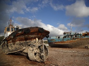 In this Wednesday, Dec. 19, 2018 photo, small boats that were recovered after spending years as shipwrecks are photographed at a dock in Elefsina, west of Athens.