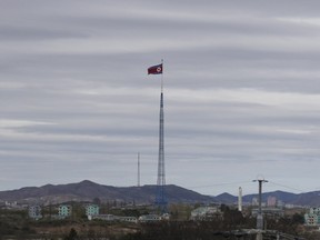 FILE - In this April 27, 2018, file photo, a North Korean flag flutters in the wind atop a 160-meter tower in North Korea's village Gijungdongseen, as seen from the Taesungdong freedom village inside the demilitarized zone in Paju, South Korea.