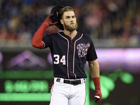 In this Sept. 7, 2018, file photo, Washington Nationals' Bryce Harper takes off his batting helmet after he flied out during the first inning of the team's baseball game against the Chicago Cubs in Washington.