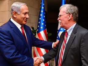 Israeli Prime Minister Benjamin Netanyahu, left, shakes hands with U.S. National Security Adviser John Bolton as they meet on Jan. 6, 2019, in Jerusalem.