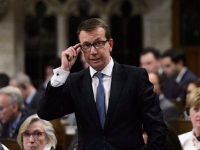 Scott Brison stands during question period in the House of Commons on Parliament Hill in Ottawa on Monday, Oct. 15, 2018.