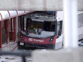 A double-decker city bus that struck a transit shelter at the start of the afternoon rush hour on Friday, remains in place at Westboro Station in Ottawa, on Saturday, Jan. 12, 2019.