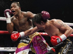 Manny Pacquiao, right, hits Adrien Broner during a WBA welterweight title boxing match Saturday, Jan. 19, 2019, in Las Vegas. (AP Photo/John Locher) ORG XMIT: NVJL201