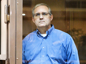 Paul Whelan, a former U.S. Marine accused of espionage and arrested in Russia, listens to his lawyers while standing inside a defendants' cage during a hearing at a court in Moscow on Jan. 22, 2019.