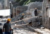 Workers stand among debris in the ancient Roman city of Pompeii, Italy.