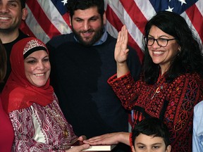 Rashida Tlaib (D-MI), wearing a traditional Palestinian robe, becomes the first Palestinian-American woman sworn into Congress as she takes the oath of office on Thomas Jefferson's English translated Quran, on January 3, 2019.