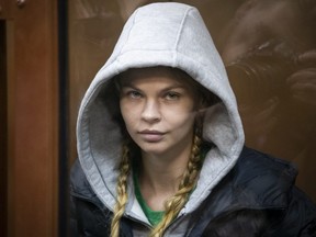 Anastasia Vashukevich, also known on social media as Nastya Rybka, sits in a cage in the court room in Moscow, Russia, Saturday, Jan. 19, 2019.