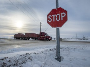 A truck goes through the intersection near the memorial for the 2018 crash where 16 people died and 13 injured when a truck crashed into the Humboldt Broncos hockey team bus, at the crash site on Wednesday, January 30, 2019 in Tisdale, Saskatchewan.