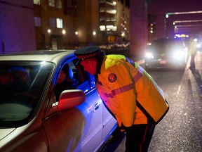 Toronto police officers stop motorists during a RIDE program spot-check in a file photo from Dec. 13, 2012.