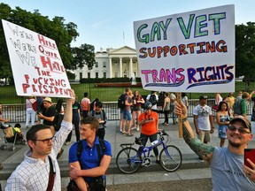 This file photo taken on July 26, 2017 shows protesters gathering in front of the White House in Washington, DC. Transgender troops can continue receiving transition-related medical treatment for now, the Pentagon said on September 18, 2017, amid mounting challenges to President Donald Trump's effective ban on funding such procedures as well as enlisting new openly transgender personnel. Trump blindsided the Pentagon in July when he tweeted that transgender troops, who had been allowed to serve openly under rules implemented by Barack Obama's administration, would be barred from the military.