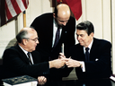 Soviet leader Mikhail Gorbachev, left, and U.S. President Ronald Reagan exchange pens during the Intermediate Range Nuclear Forces Treaty signing ceremony in the White House on Dec. 8, 1987.