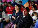 Migrants mainly from Mexico and Central America look on as U.S. President Donald Trump gives a prime-time address about border security on television, Jan. 8, 2019, watching from a border migrant shelter in Tijuana, Mexico.