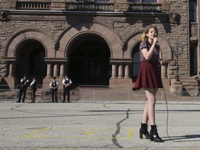 Rayne Fisher-Quann, the 16-year-old co-organizer of March for Our Education, speaks to a group of over 100 students and supporters on the front lawn of the Ontario Legislature on Sunday September 23, 2018.