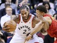 Toronto Raptors forward Kawhi Leonard (2) takes control of the ball beside Atlanta Hawks guard Trae Young (11) in Toronto, Ont. on Tuesday January 8, 2019.