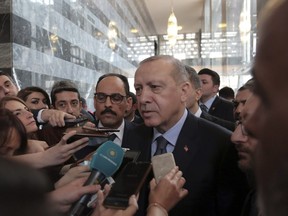 Turkey's President Recep Tayyip Erdogan speaks to the media at the parliament in Ankara, Turkey,