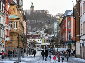 People walk through the city centre of Amberg, southern Germany, on Jan. 2, 2019.