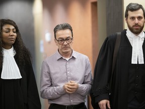 Michel Cadotte with his lawyers, Elfride Duclervil, left, and Nicolas Welt, in Montreal.