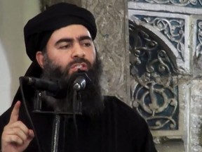 This image made from video posted on a militant website July 5, 2014, purports to show the leader of ISIL Abu Bakr al-Baghdadi delivering a sermon at a mosque in Iraq during his first public appearance.