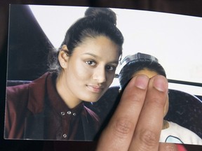 In this file photo taken on Feb. 22, 2015 Renu Begum, eldest sister of missing British girl Shamima Begum, holds a picture of her sister while being interviewed by the media in central London.