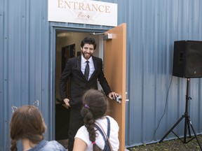 Syrian chocolatier Tareq Hadhad greets children at the door of Peace By Chocolate's factory in Antigonish, N.S.