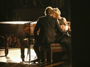 Bradley Cooper slips his arm around Lady Gaga as they perform "Shallow."