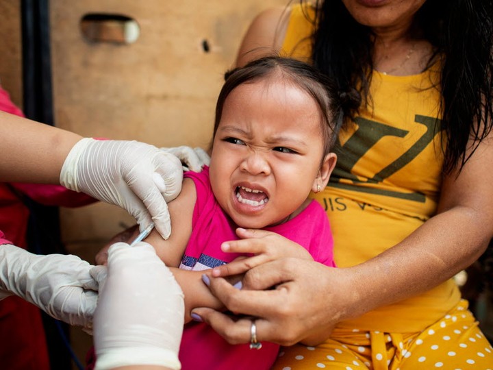  A child reacts during a Philippine Read Cross Measles Outbreak Vaccination Response in Baseco compound, a slum area in Manila on February 16, 2019. An ongoing measles outbreak in the country has killed more than 100 people.