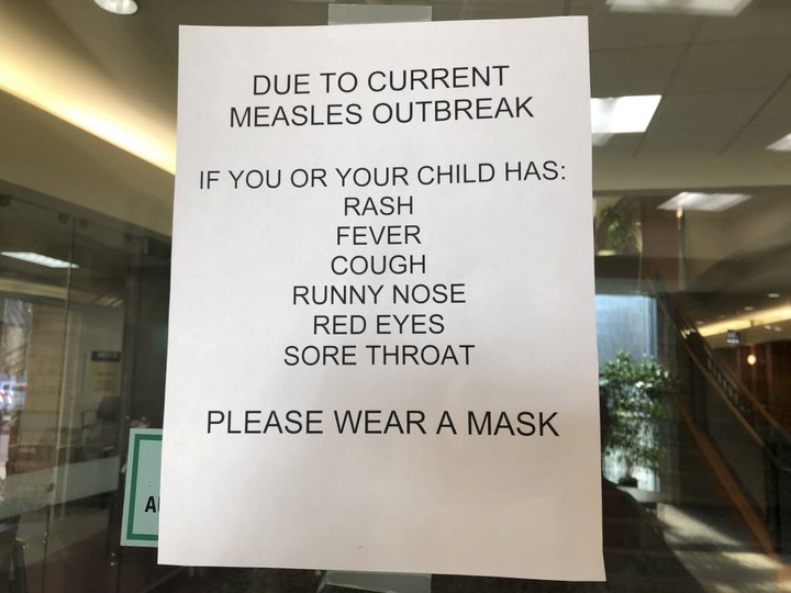  Signs posted at The Vancouver Clinic in Vancouver, Wash., warn patients and visitors of a measles outbreak on Wednesday, Jan. 30, 2019. The outbreak has sickened 39 people in the U.S. Pacific Northwest, with 13 other cases suspected.