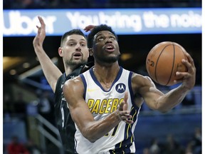 Indiana Pacers' Thaddeus Young, right, looks to shoot in front of Orlando Magic's Nikola Vucevic during the first half of an NBA basketball game, Thursday, Jan. 31, 2019, in Orlando, Fla.