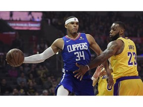 Los Angeles Clippers forward Tobias Harris, left, passes the ball as Los Angeles Lakers forward LeBron James defends during the first half of an NBA basketball game Thursday, Jan. 31, 2019, in Los Angeles.