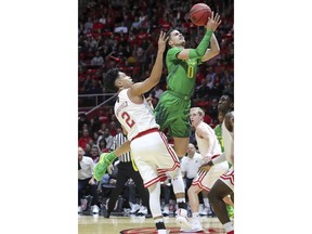 Oregon guard Will Richardson (0) is fouled by Utah guard Sedrick Barefield (2) during the first half of an NCAA college basketball game Thursday, Jan. 31, 2019, in Salt Lake City.