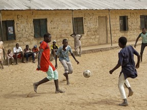 Children play football in the sandy courtyard of Badawa Girls School, which would have been used as a polling station, in Kano, northern Nigeria, Saturday, Feb. 16, 2019. A civic group monitoring Nigeria's now-delayed election says the last-minute decision to postpone the vote a week until Feb. 23 "has created needless tension and confusion in the country."