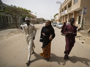 In this photo taken Friday, Feb. 15, 2019, Zainab Sulaiman Umar, 26, center, a candidate for the State House of Assembly in Kumbotso constituency, Kano state, speaks to residents in Kano, northern Nigeria. Umar is among dozens of first-time female candidates in a country where the percentage of women in parliament is one of the lowest in the world, under 7 percent, and the idea of a female president brings a belly laugh from many men.