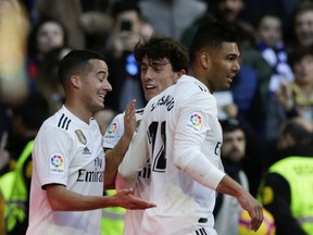 Real Madrid's Casemiro, right, celebrates with teammates Lucas Vazquez, left, and Alvaro Odriozola after scoring his team's first goal during a La Liga soccer match between Real Madrid and Girona at the Bernabeu stadium in Madrid, Spain, Sunday, Feb. 17, 2019.