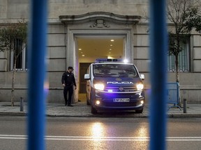 A Spanish National Police van, allegedly carrying Catalonian politicians and activists, arrives at the Spanish Supreme Court in Madrid, Wednesday, Feb. 13, 2019. A politically charged trial of a dozen Catalan separatist leaders began Tuesday in Spain's Supreme Court amid protests and the possibility of an early general election being called in the country.