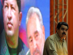 In this file photo taken on December 14, 2016, Venezuelan President Nicolas Maduro delivers a speech at the XII Anniversary of the Bolivarian Alliance for the Peoples of Our America (ALBA) at the Convention Palace in Havana, in front of a poster of the late Venezuelan and Cuban leaders Hugo Chavez and Fidel Castro.