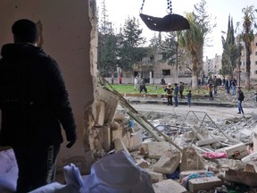 A Syrian man checks the scene of a double attack in Syria's northwestern jihadist-held city of Idlib, on February 18, 2019.