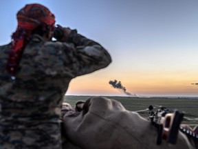 A Syrian Democratic Forces (SDF) fighter inspects the embattled village of Baghouz in Syria's northern Deir Ezzor province on February 19, 2019.