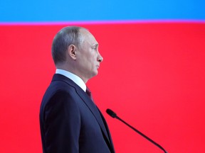 Russian President Vladimir Putin, officials and other attendees listen to the national anthem at the end of Vladimir Putin's annual state of the nation address in Moscow on February 20, 2019.