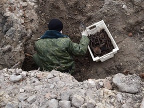 Belarus' servicemen excavate a mass grave for the prisoners of a Jewish ghetto set up by the Nazis during the Second World War, that was uncovered at a construction site in the city of Brest, on February 27, 2019.