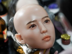 This photo taken on Feb. 1, 2018 shows a worker painting the face of a silicone doll at a factory of EXDOLL, a firm based in the northeastern Chinese port city of Dalian.